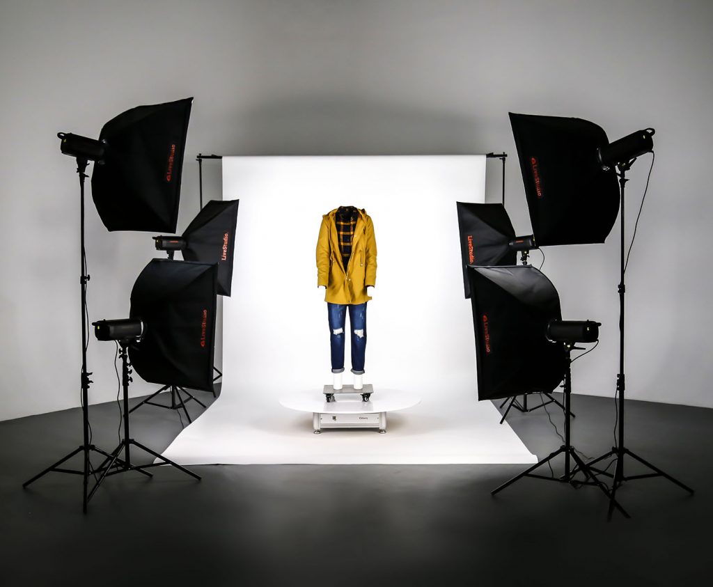 Mannequin on turntable in a studio with photography lights on either side